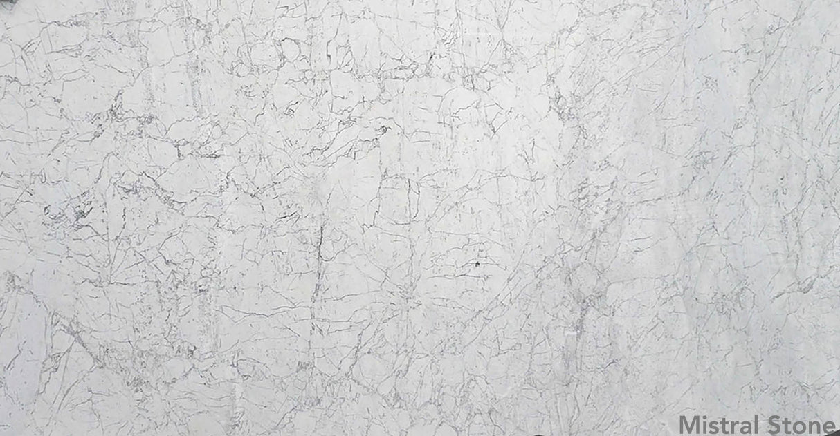 Bianco Carrara premium Italian white marble slab also known as Carrara White featuring timeless soft grey feathered veining with customizable finishes by Mistral Stone