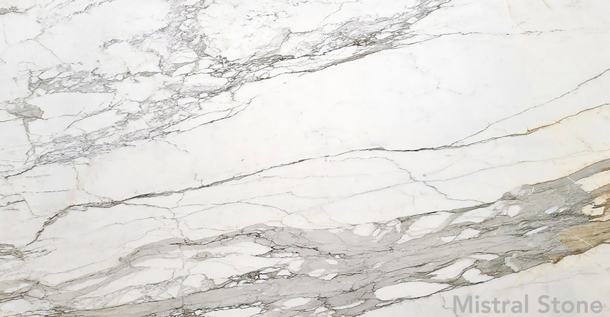 Calacatta Borghini premium Italian white marble slab featuring iconic bold grey and deep honey gold veining with customizable finishes by Mistral Stone