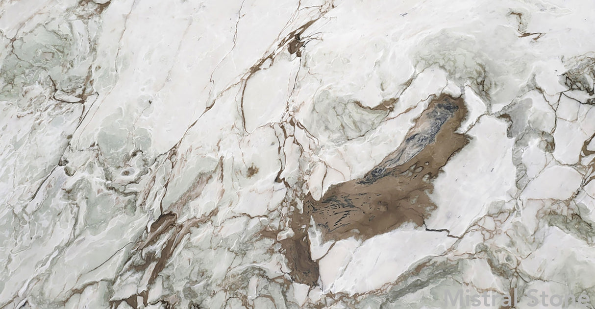 Premium Calacatta Giotto marble slab featuring an artistic multi-color topography of seafoam green and tobacco brown veins on a luminous white background with customizable finishes by Mistral Stone
