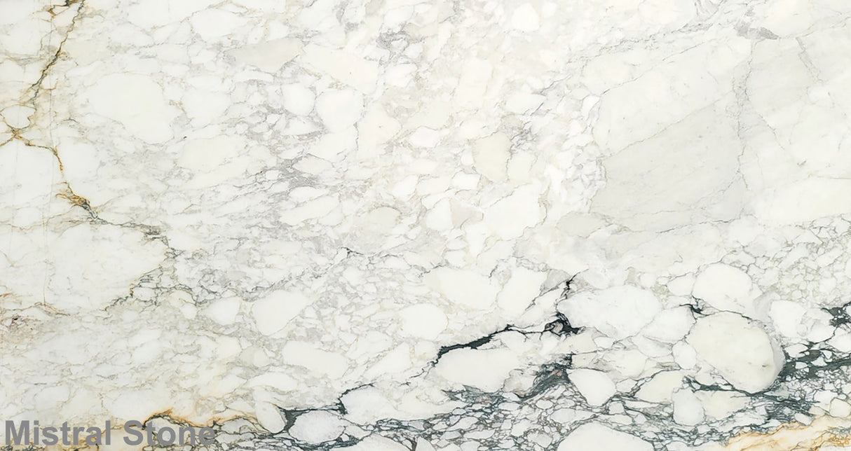 Premium Calacatta Soft Monet marble slab featuring a soft brecciated alabaster white canvas with subtle sage green, light gold, and charcoal grey pathways with customizable finishes by Mistral Stone