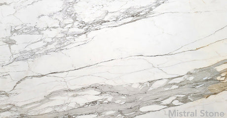 Calacatta Borghini premium Italian white marble slab featuring iconic bold grey and deep honey gold veining with customizable finishes by Mistral Stone