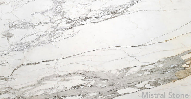 Calacatta Borghini premium Italian white marble slab featuring iconic bold grey and deep honey gold veining with customizable finishes by Mistral Stone