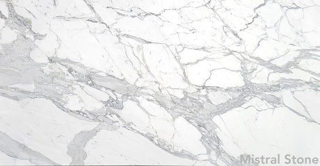 Premium Calacatta Extra marble slab featuring a luminous pristine white background with dramatic bold grey and pewter veining with customizable finishes by Mistral Stone