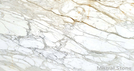 Premium Calacatta Gold marble slab featuring a luminous white background with dramatic grey and rich honey gold veining with customizable finishes by Mistral Stone