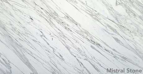 Calacatta premium Italian white marble slab featuring iconic bold diagonal grey veining on a luminous white background with customizable finishes by Mistral Stone