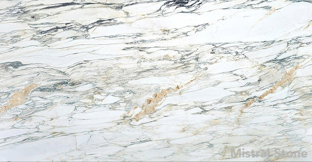 Premium Calacatta Monet marble slab featuring a painterly impressionist matrix of sage green ochre gold and charcoal grey veins on a luminous white background with customizable finishes by Mistral Stone