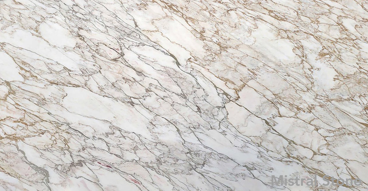 Premium Calacatta Oro marble slab featuring an intricate network of rich honey gold amber and elegant grey veining on a luminous white background with customizable finishes by Mistral Stone