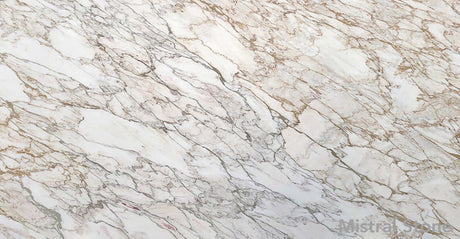Premium Calacatta Oro marble slab featuring an intricate network of rich honey gold amber and elegant grey veining on a luminous white background with customizable finishes by Mistral Stone
