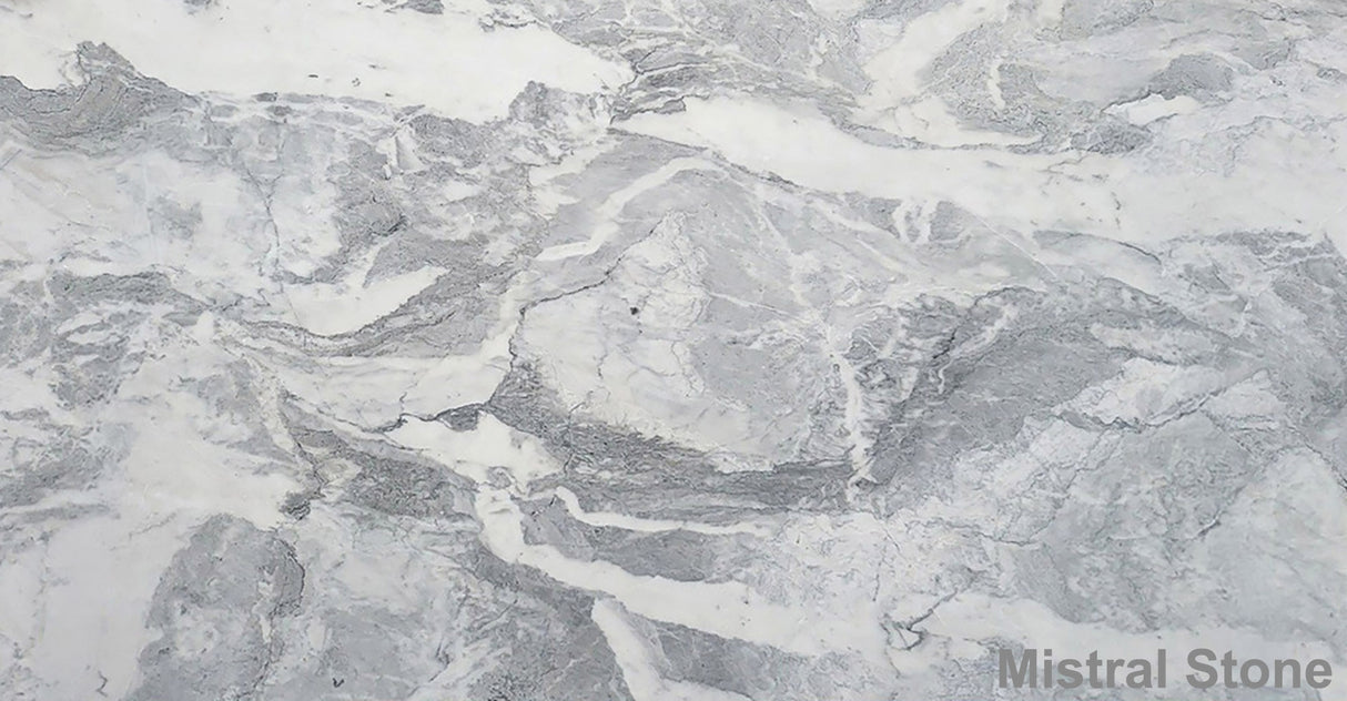 Premium Calacatta Versilia marble slab featuring a dramatic stormy wave matrix of dove grey ash slate and silver veining on a luminous white background with customizable finishes by Mistral Stone